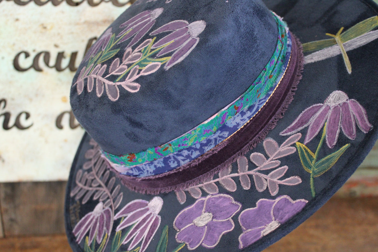 “Wildflower Melody: The Hand painted Hat with a Symphony of Style and Song”