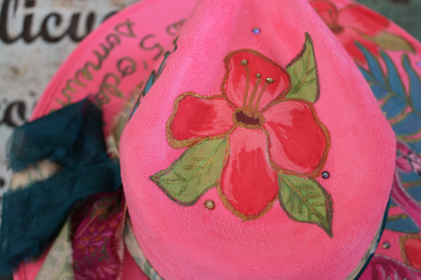 “Flamingo Fiesta: A Hand-Painted Hat with Swarovski Sparkle and Song Lyrics”